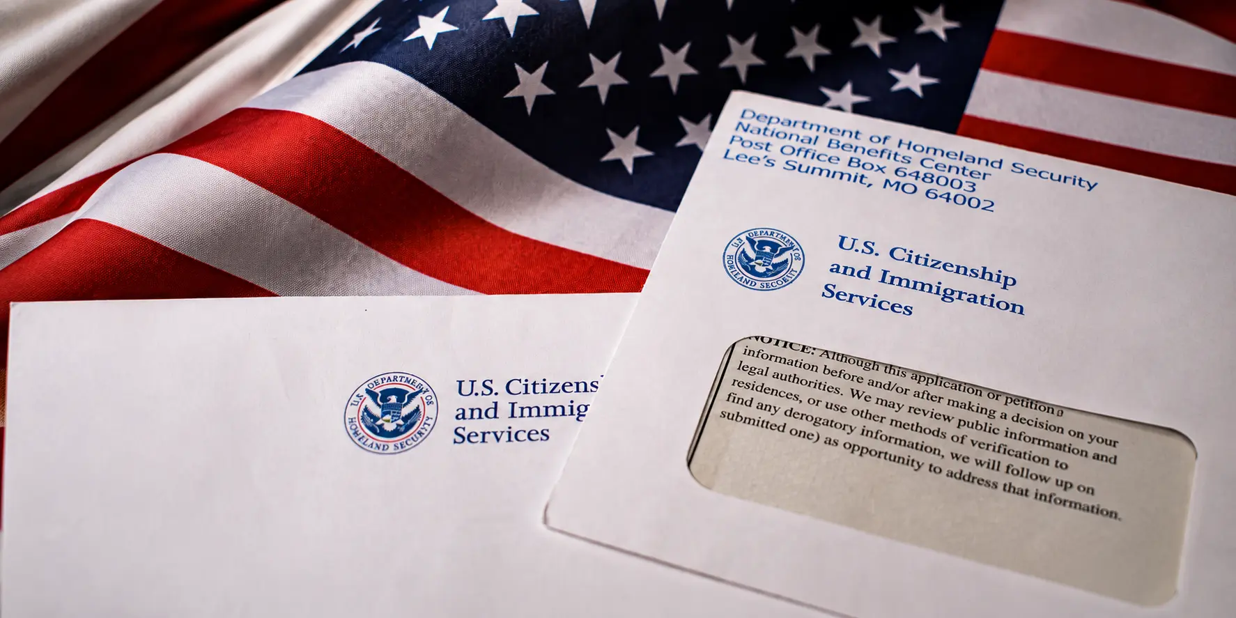 USCIS documents beside a United States flag