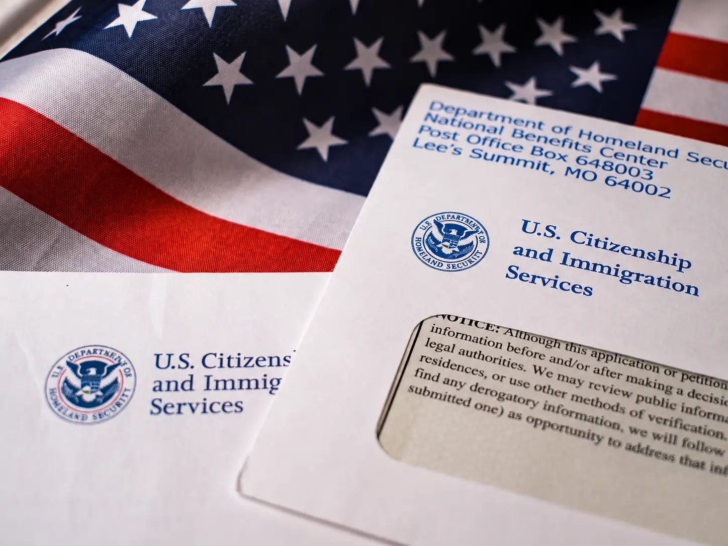 USCIS documents beside a United States flag